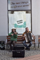Romania, Timis, Timisoara, Buskers playing accordion and fiddle, old town.
