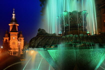 Romania, Timis, Timisoara, Colourfully lit (green) fountain and Metropolitan Orthodox Cathedral at night, Piata Victoriei , old town.
