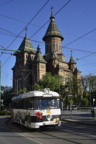 Romania, Timis, Timisoara, Odl style tram passing Metropolitan Orthodox Cathedral, old town.