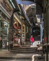 Israel, Jerusalem, A little Arab boy on the stairs of the narrow Via Dolorosa in the Muslim Quarter of the Old City. The Old City of Jerusalem and its Walls is a UNESCO World Heritage Site.