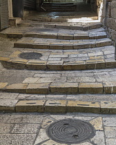 Israel, Jerusalem, The ancient stairs of the narrow Via Dolorosa in the Muslim Quarter of the Old City. The Old City of Jerusalem and its Walls is a UNESCO World Heritage Site.