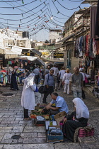 Israel, Jerusalem, Shoppers in the street market by the Damascus Gate in the Muslim Quarter of the Old City. The Old City of Jerusalem and its Walls is a UNESCO World Heritage Site.