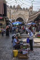 Israel, Jerusalem, Shoppers in the street market by the Damascus Gate in the Muslim Quarter of the Old City. The Old City of Jerusalem and its Walls is a UNESCO World Heritage Site.