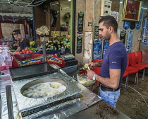 Israel, Jerusalem, A Palestinian Arab man makes falafels in the street market by the Damascus Gate in the Muslim Quarter of the Old City. The Old City of Jerusalem and its Walls is a UNESCO World Heri...