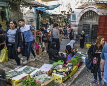 Israel, Jerusalem, Palestinian Arab women in tradtional dress sell produce in the street market by the Damascus Gate in the Muslim Quarter of the Old City of Jerusalem. The Old City of Jerusalem and i...