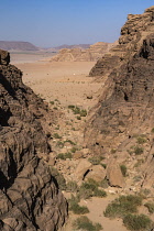 Jordan, Wadi Rum Protected Area, A canyon through the mountains to desert below in the Wadi Rum Protected Area, a UNESCO World Heritage Site.