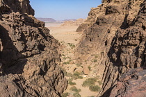 Jordan, Wadi Rum Protected Area, A canyon through the mountains to desert below in the Wadi Rum Protected Area, a UNESCO World Heritage Site.