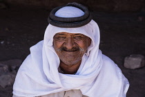 Jordan, Petra, A Bedouin man wearing a keffiyeh (head scarf) and agal (rope headband) in Petra in the Petra Archeological Park is a Jordanian National Park and a UNESCO World Heritage Site.