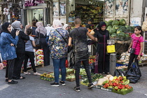 Israel, Jerusalem, East Jerusalem, Palestinian Arab women wearing the traditional Muslim hajibs or head scarfs shopping for fresh produce on Nablus Street by the Damascus Gate.