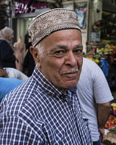 Israel, Jerusalem, East Jerusalem, A Palestinian Arab man wearing an ornately decorated taqiyah or skull cap. Many Muslim men wear the taqiyah to emulate Mohammed, who always had his head coveredl.