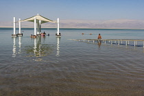 Israel, Ein Bokek, Dead Sea, Visitors relax in the warm waters of the Dead Sea at the resort of Ein Bokek in Israel.
