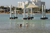 Israel, Ein Bokek, Dead Sea, A young woman floats in the bouyant waters of the Dead Sea at the resort of Ein Bokek in Israel.