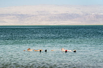 Israel, Ein Bokek, Dead Sea, Two young men float in the bouyant waters of the Dead Sea at the resort of Ein Bokek in Israel.
