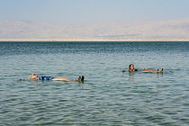 Israel, Ein Bokek, Dead Sea, Two women relax and float in the warm, bouyant waters of the Dead Sea at the resort of Ein Bokek in Israel.