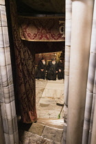 Palestine, Bethlehem, Priests in the Grotto of the Nativity in the Church of the Nativity in Bethlehem in the Occupied West Bank. The original basilica was built in 339 A.D. over the Nativity Grotto w...