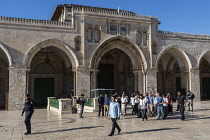 Israel, Jerusalem, Jewish visitors, many barefooted, accompanied by Arab and Israeli security police, walk in front of the facade of the al-Aqsa Mosque on the Temple Mount or al-Haram ash-Sharif in th...