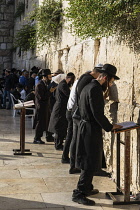 Israel, Jerusalem, Western Wall, Jewish men worship at the Western Wall of the Temple Mount in the Jewish Quarter of the Old City. The Old City of Jerusalem and its Walls is a UNESCO World Heritage Si...