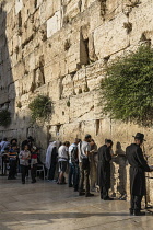 Israel, Jerusalem, Western Wall, A group of Jewish men and boys worship at the Western Wall of the Temple Mount in the Jewish Quarter of the Old City. The Old City of Jerusalem and its Walls is a UNES...