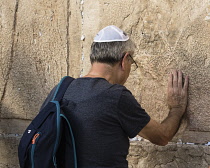 Israel, Jerusalem, Western Wall, A Jewish man worships at the Western Wall of the Temple Mount in the Jewish Quarter of the Old City. The Old City of Jerusalem and its Walls is a UNESCO World Heritage...