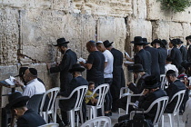 Israel, Jerusalem, Western Wall, Jewish men worship at the Western Wall of the Temple Mount in the Jewish Quarter of the Old City. The Old City of Jerusalem and its Walls is a UNESCO World Heritage Si...