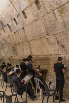 Israel, Jerusalem, Western Wall, Jewish men worship in the synagogue under Wilson's Arch at the Western Wall of the Temple Mount in the Jewish Quarter of the Old City. The Old City of Jerusalem and it...