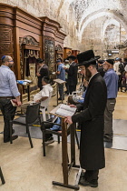 Israel, Jerusalem, Western Wall, Jewish men worship in the synagogue under Wilson's Arch at the Western Wall of the Temple Mount in the Jewish Quarter of the Old City. The Old City of Jerusalem and it...