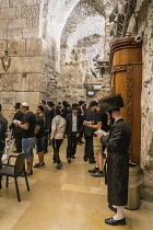 Israel, Jerusalem, Western Wall, Jewish men worship in the synagogue under Wilson's Arch at the Western Wall of the Temple Mount in the Jewish Quarter of the Old City. The Old City of Jerusalem and it...