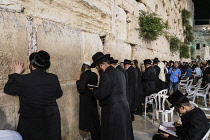 Israel, Jerusalem, Western Wall, Jewish men worship at the Western Wall of the Temple Mount in the Jewish Quarter of the Old City. The Old City of Jerusalem and its Walls is a UNESCO World Heritage Si...