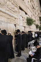 Israel, Jerusalem, Western Wall, Jewish men worship at the Western Wall of the Temple Mount in the Jewish Quarter of the Old City. The Old City of Jerusalem and its Walls is a UNESCO World Heritage Si...