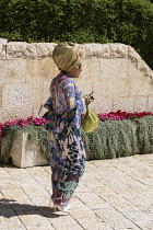 Israel, Jerusalem, Jewish Quarter, A woman dressed up to attend a bar mitzvah celebration in the Jewish Quarter of the Old City. The Old City of Jerusalem and its Walls is a UNESCO World Heritage Site...