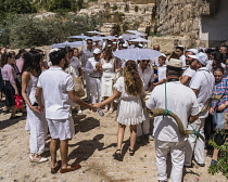Israel, Jerusalem, Jewish Quarter, A bar mitzvah procession moves toward the entrance to the Jewish Quarter of the Old City. Musicians with kudu horn shofars play the saxophone whle participants dance...