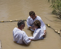 Palestine, Occupied Palestinian Territory, Qasr el Yahud, Christian pilgrims being baptized in the River Jordan at Qasr el Yahud on the Palestine side of the river in the Occupied Territory of the Wes...