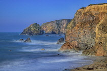 Ireland, County Waterford, Kilfarrasy Beach with rocky headland.