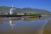 Ireland, County Kerry, Blennerville, Blennerville Windmill seen from across Tralee Bay estuary with its reflection in the water and mountains of the Dingle Peninsula in the background.