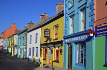 Ireland, County Kerry, Dingle, Evening shadows on a colourful row of houses on Strand Street.