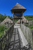 Ireland, County Clare, Quin, Craggaunowen, The Living Past Experience, Reconstruction of a crannog with wooden fenced pathway leading in to settlement area.