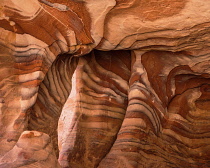 Jordan, Petra, Iron and manganese oxides as well as hydroxide minerals within the Umm Ishrin sandstone create these colorful patterns in the rock walls of Petra in the Petra Archeological Park is a Jo...