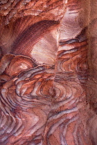 Jordan, Petra, Iron and manganese oxides as well as hydroxide minerals within the Umm Ishrin sandstone create these colorful patterns in the rock walls of Petra in the Petra Archeological Park is a Jo...