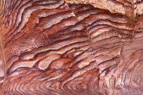 Jordan, Petra, Iron and manganese oxides as well as hydroxide minerals within the Umm Ishrin sandstone create these colorful patterns in the rock walls of Petra in the Petra Archeological Park is a Jo...