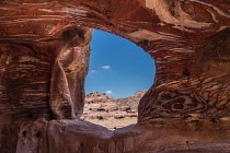 Jordan, Petra, Iron and manganese oxides as well as hydroxide minerals within the Umm Ishrin sandstone create these colorful patterns in this tomb cut into the rock walls of Petra in the Petra Archeol...