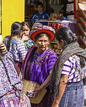 Guatemala, Solola Department, Santiago Atitlan, Older Mayan women in traditional dress in the weekly open market.  One woman wears the tocoyal head wrap characteristic to this town.  It was once commo...