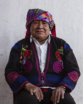 Guatemala, El Quiche Department, Chichicastenango, A Quiche Mayan man wearing the headdress of a cofrade, or religious officer of the cofradia.