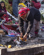 Guatemala, El Quiche Department, Chichicastenango, A Quiche Mayan man prepares an offering of candles to the Mayan gods on the steps of the Church of Santo Tomas. The church was built about 1545 A.D....