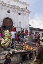 Guatemala, El Quiche Department, Chichicastenango, An offering to the Mayan gods burns on an altar on the steps of the Church of Santo Tomas. The church was built on the platform of a Mayan temple pyr...