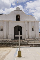 Guatemala, Solola Department, Santa Cruz la Laguna, A small, simple Catholic church with a cross on the plaza or town square in front.