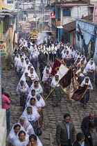 Guatemala, Solola Department, San Pedro la Laguna, Catholic procession of the Virgin of Carmen. Women in traditional Mayan dress with white mantillas over their heads.  Women carry the image of the Vi...