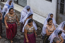 Guatemala, Solola Department, San Pedro la Laguna, Catholic procession of the Virgin of Carmen. Women in traditional Mayan dress with embroidered white lmantillas over their heads.