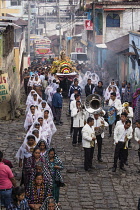 Guatemala, Solola Department, San Pedro la Laguna, A band plays in the Catholic procession of the Virgin of Carmen. Women in traditional Mayan dress with white mantillas over their heads.  Women carry...