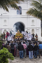 Guatemala, Solola Department, San Pedro la Laguna, Catholic procession of the Virgin of Carmen. Women in traditional Mayan dress with white mantillas over their heads.  Women carry the image of the Vi...