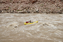 USA, Utah, Canyonlands National Park, An 18' rowing raft navigates through the Big Drop II rapid in Cataract Canyon on the Colorado River.  Flow level was 51,000 cfs.